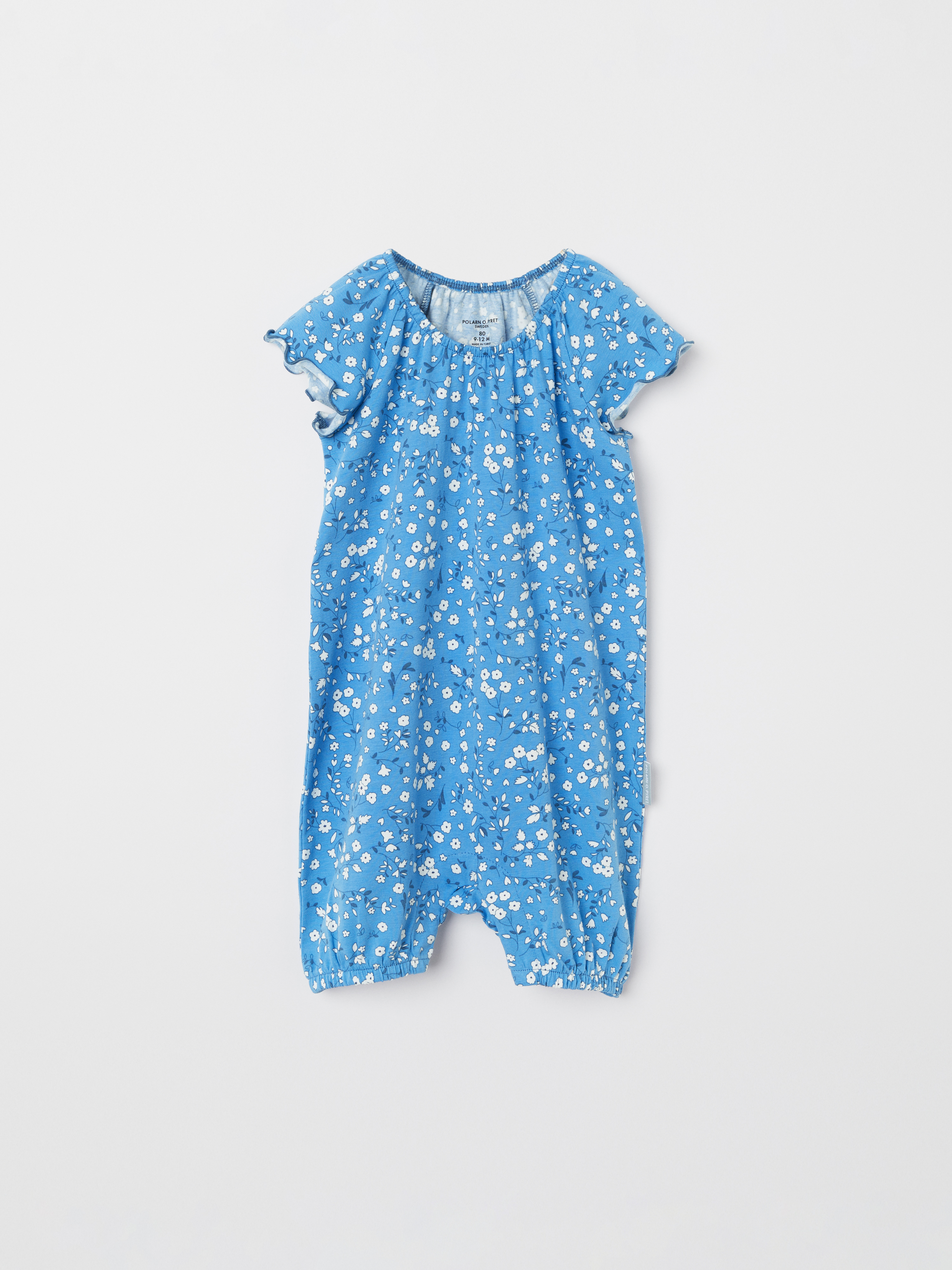 Läs mer om Playsuit med blomtryck baby blå denim